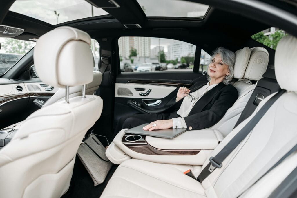 pexels-photo-8425026-8425026 Senior woman relaxing in a luxurious car interior, enjoying the comfort and modern design.